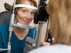 Image of an elderly woman getting an eye exam.