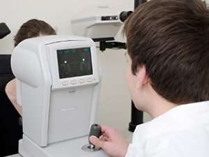 Image of an optometrist using an eye examination machine.