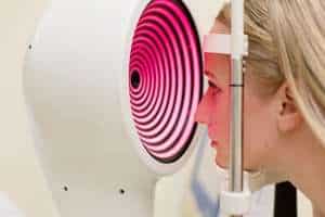 woman undergoing cornea curvature testing