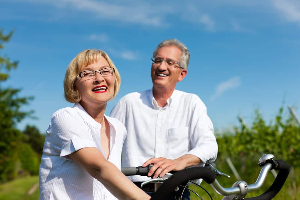 two senior citizens riding bikes