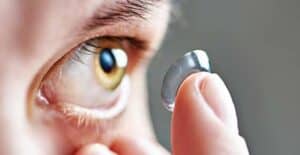 Image of someone putting in a contact lens. 